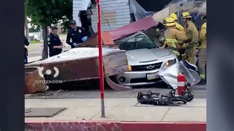 Person trapped in car after collision into South L.A. building